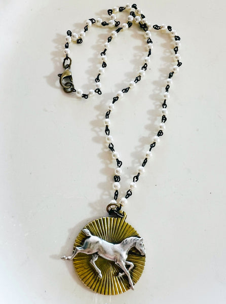 Necklace with a horse pendant on a white background