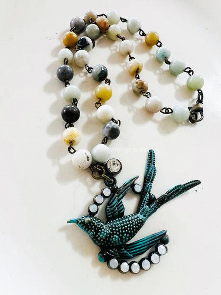 Necklace with a bird-shaped pendant on a white background