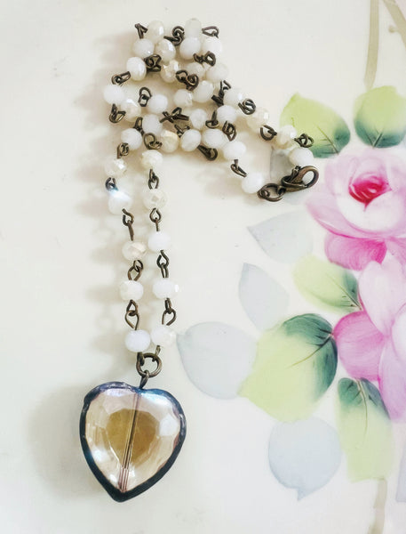 Necklace with a heart-shaped pendant on a floral background