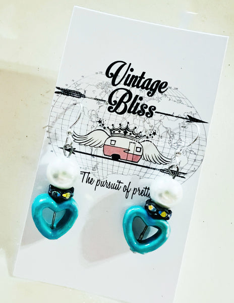 Turquoise heart-shaped earrings on a 'Vintage Bliss' branded card.