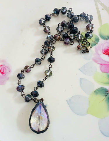 Necklace with a teardrop-shaped pendant on a floral background