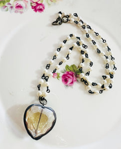 Necklace with a heart-shaped pendant on a floral background