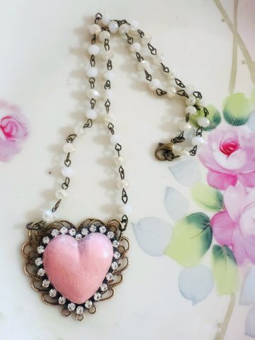Necklace with a pink heart pendant on a floral background