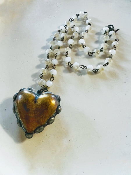 Necklace with a heart-shaped pendant on a light background