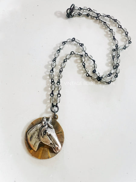 Necklace with horse head pendant on a white background