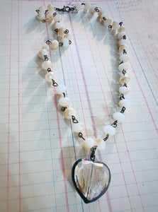 Necklace with heart-shaped pendant on a grid background