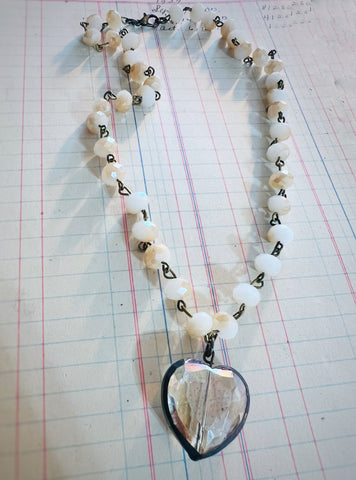 Necklace with heart-shaped pendant on a grid background