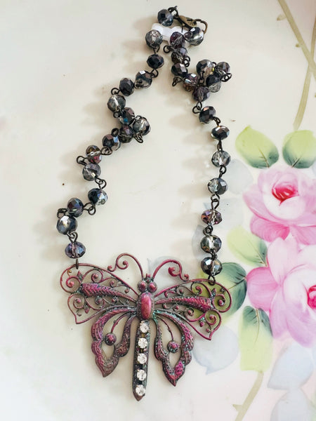 Necklace with butterfly pendant on a floral background