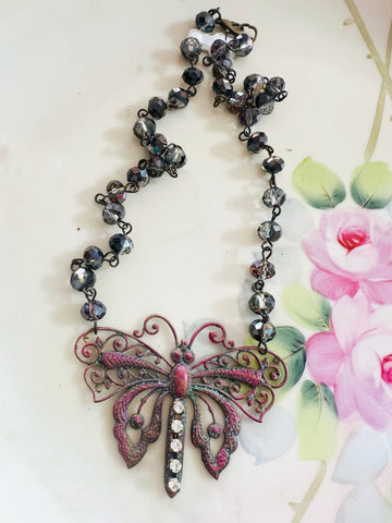 Necklace with butterfly pendant on a floral background